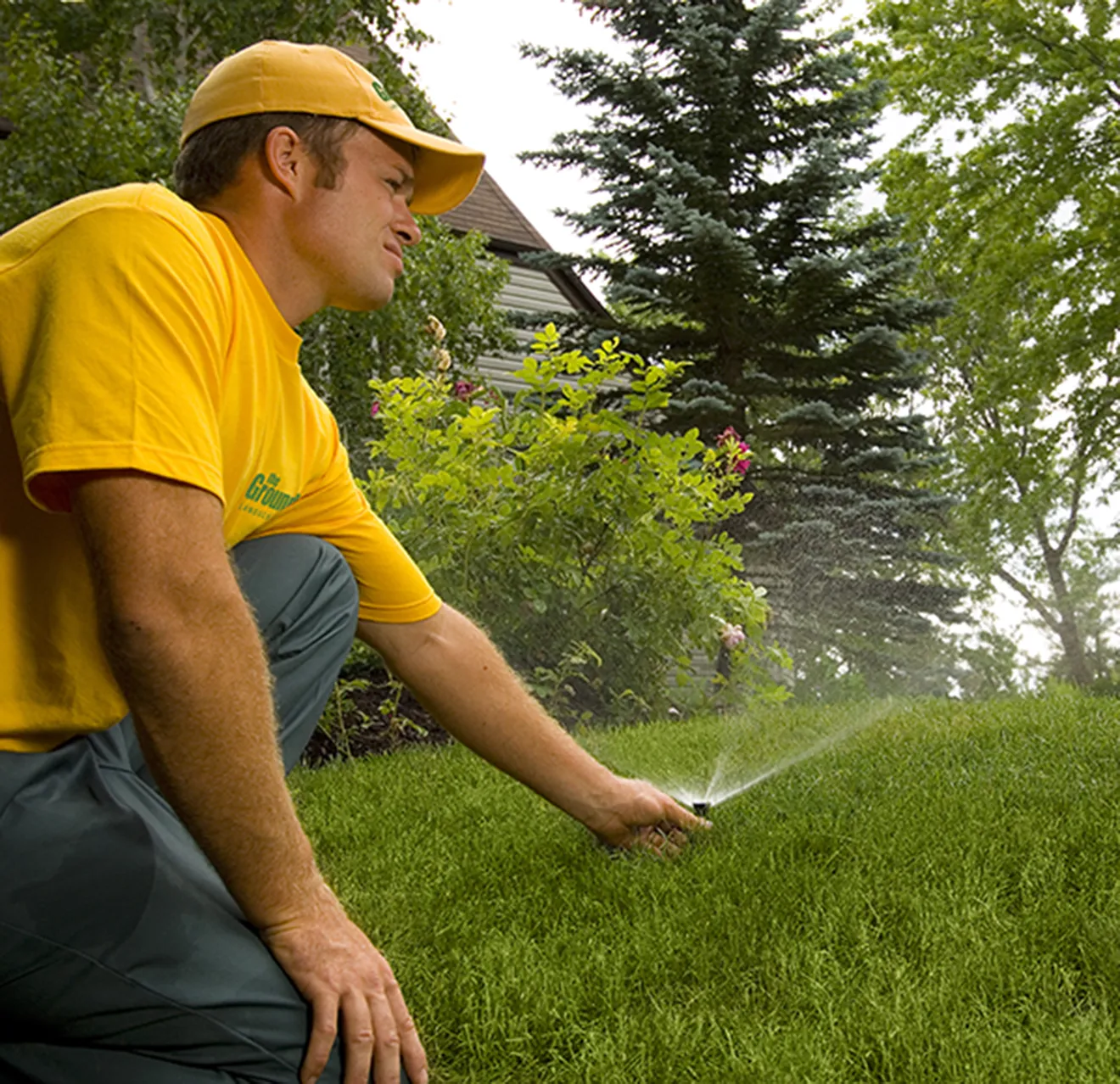 Grounds Guys installing irrigation.