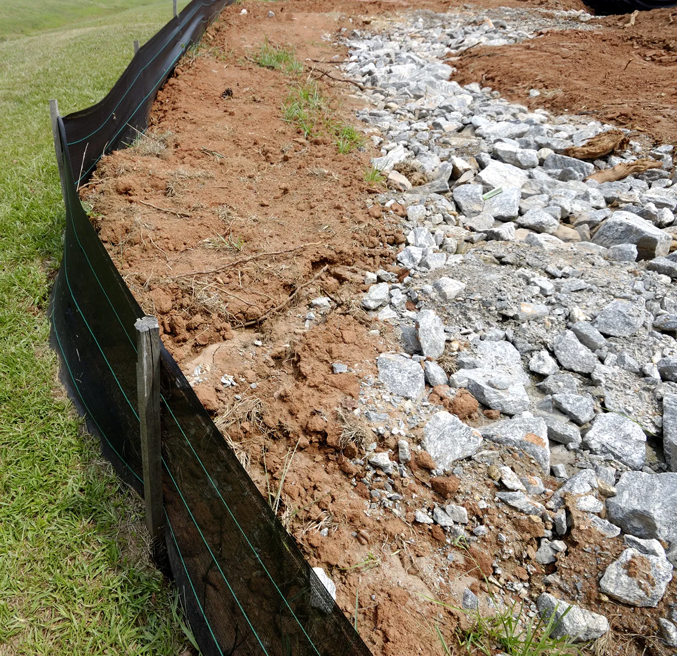 Silt fencing with soil against it showing erosion control.