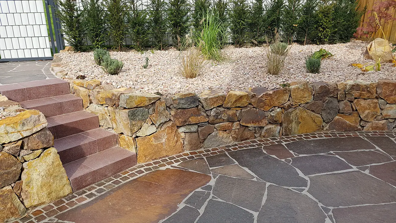 Stone garden with drywall, screen, and fence.