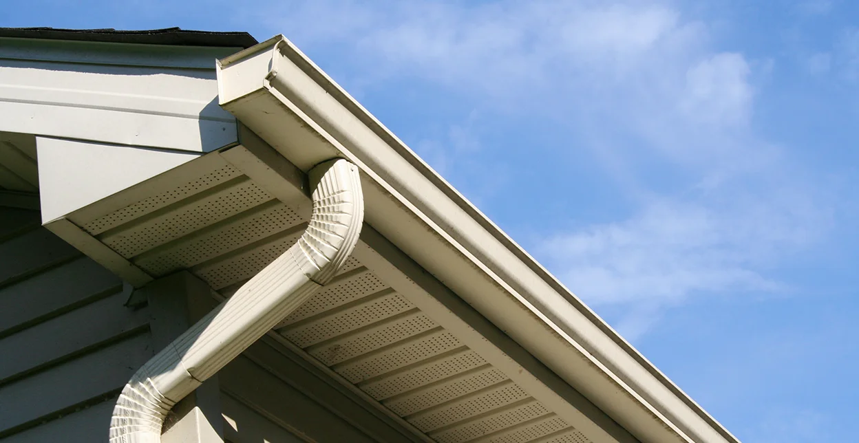 The gutters, downspout, and eaves of a home.