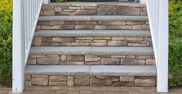 A stone staircase flanked by hedges.