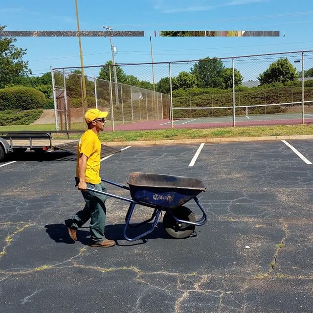 A Man pushing a handcart