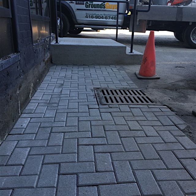 A new stone pavement near a road.