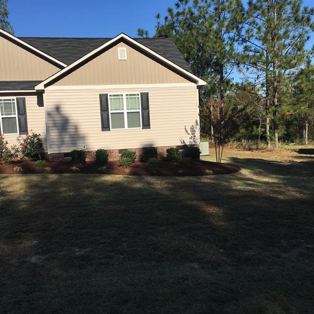 A side view of the garden of a house.