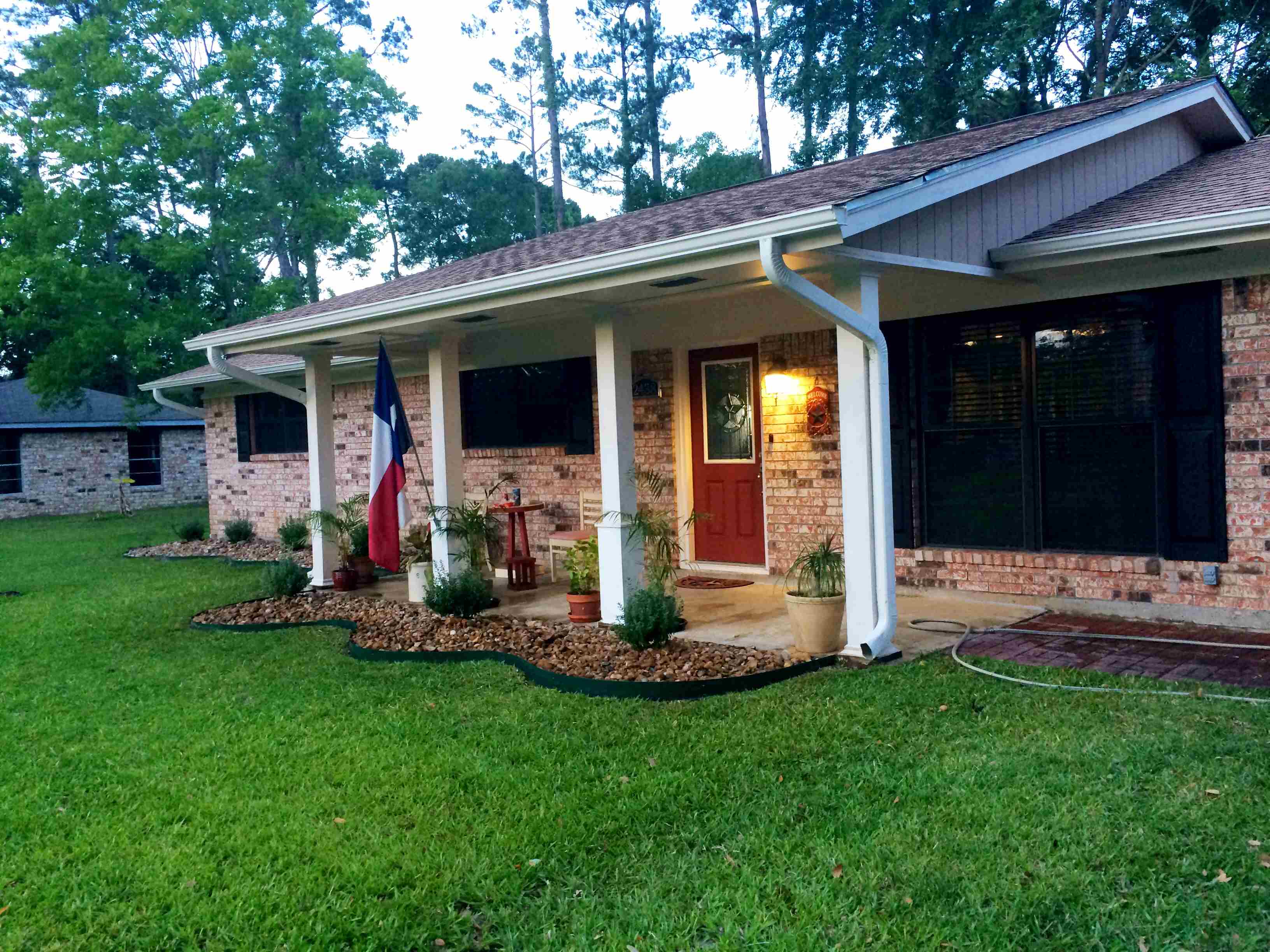 Brick home with manicured yard 