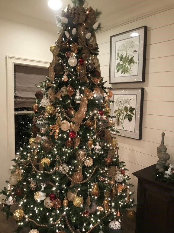 Decorated christmas tree with white wall paneling