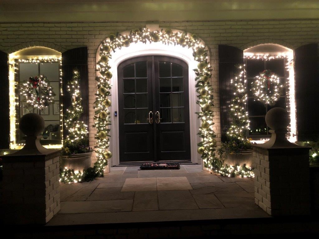 Double front door with lighting and wreaths 