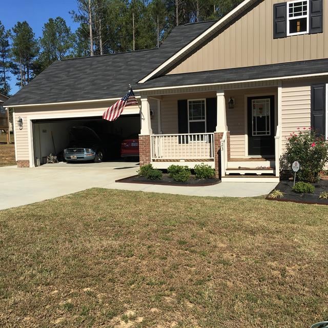 Front view of a house with a car porch.