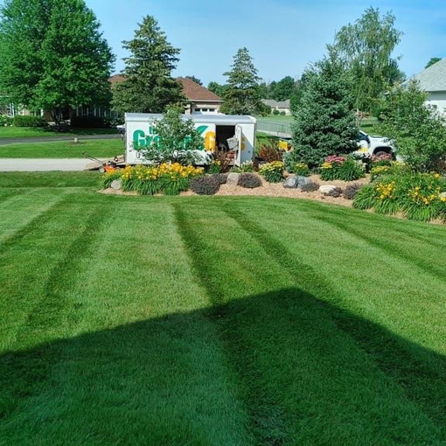 Garden and lawn care with ground guys van.