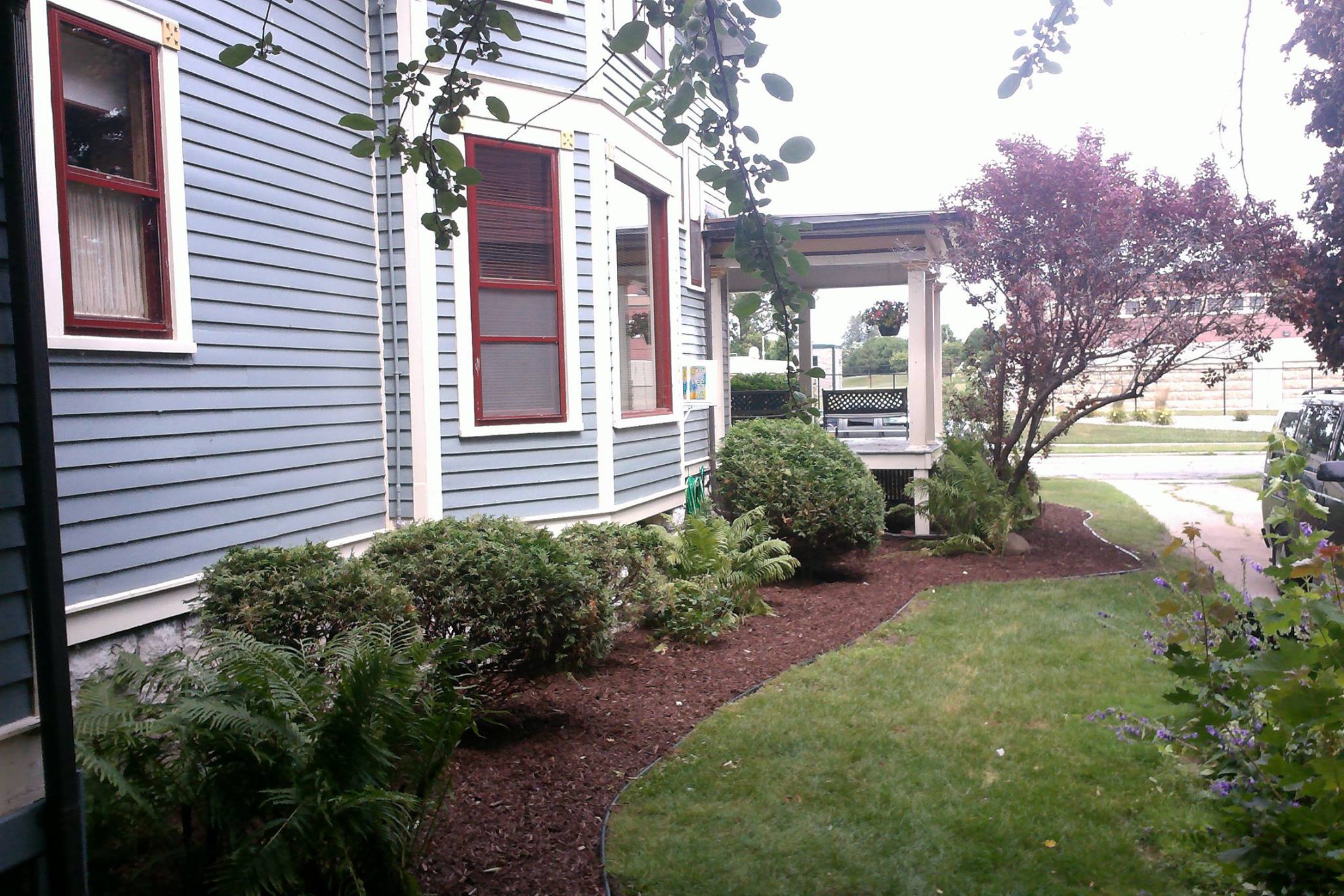 Well manicured lawn and planters on side of house