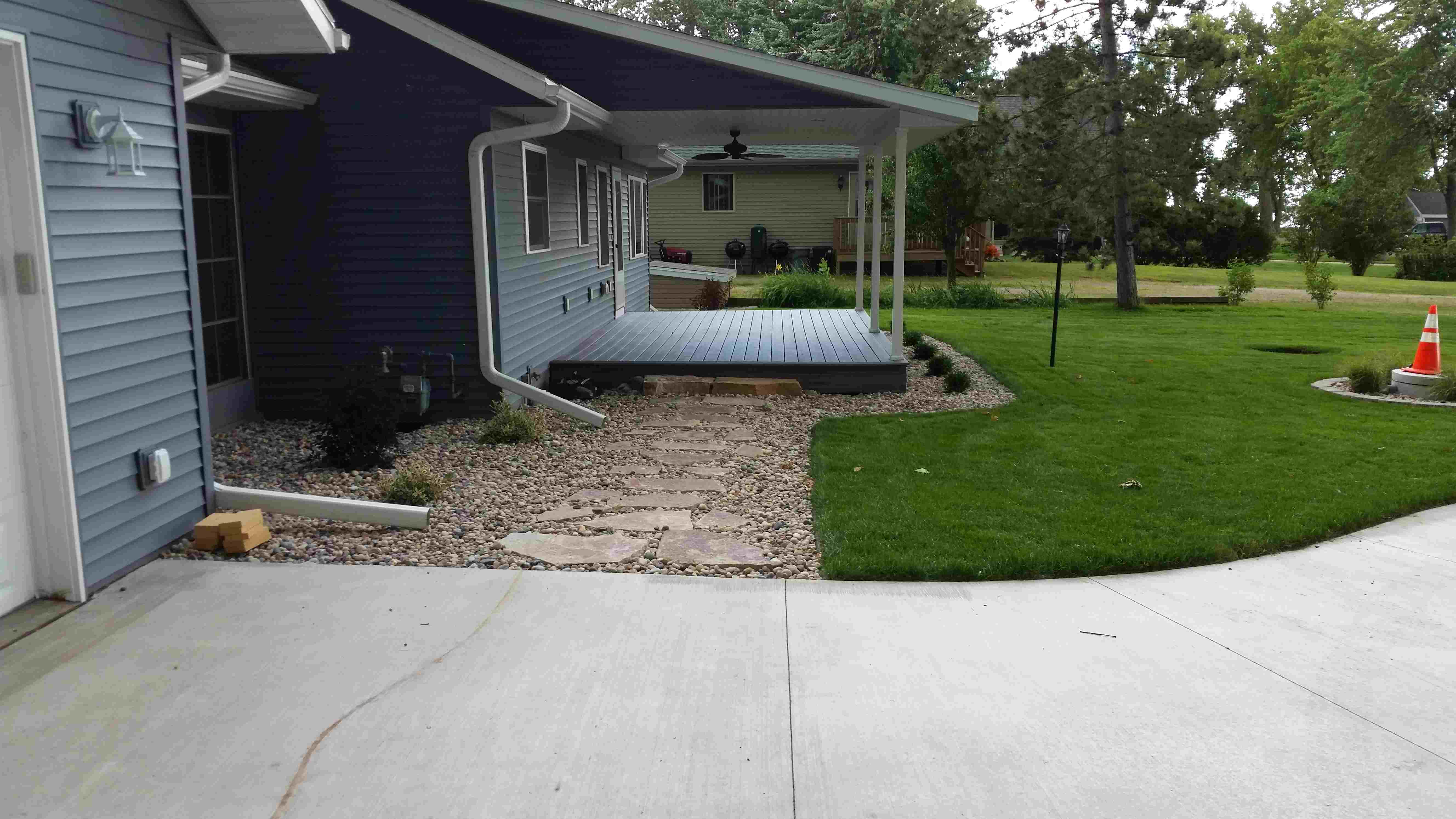 Rock walkway connecting driveway to front porch