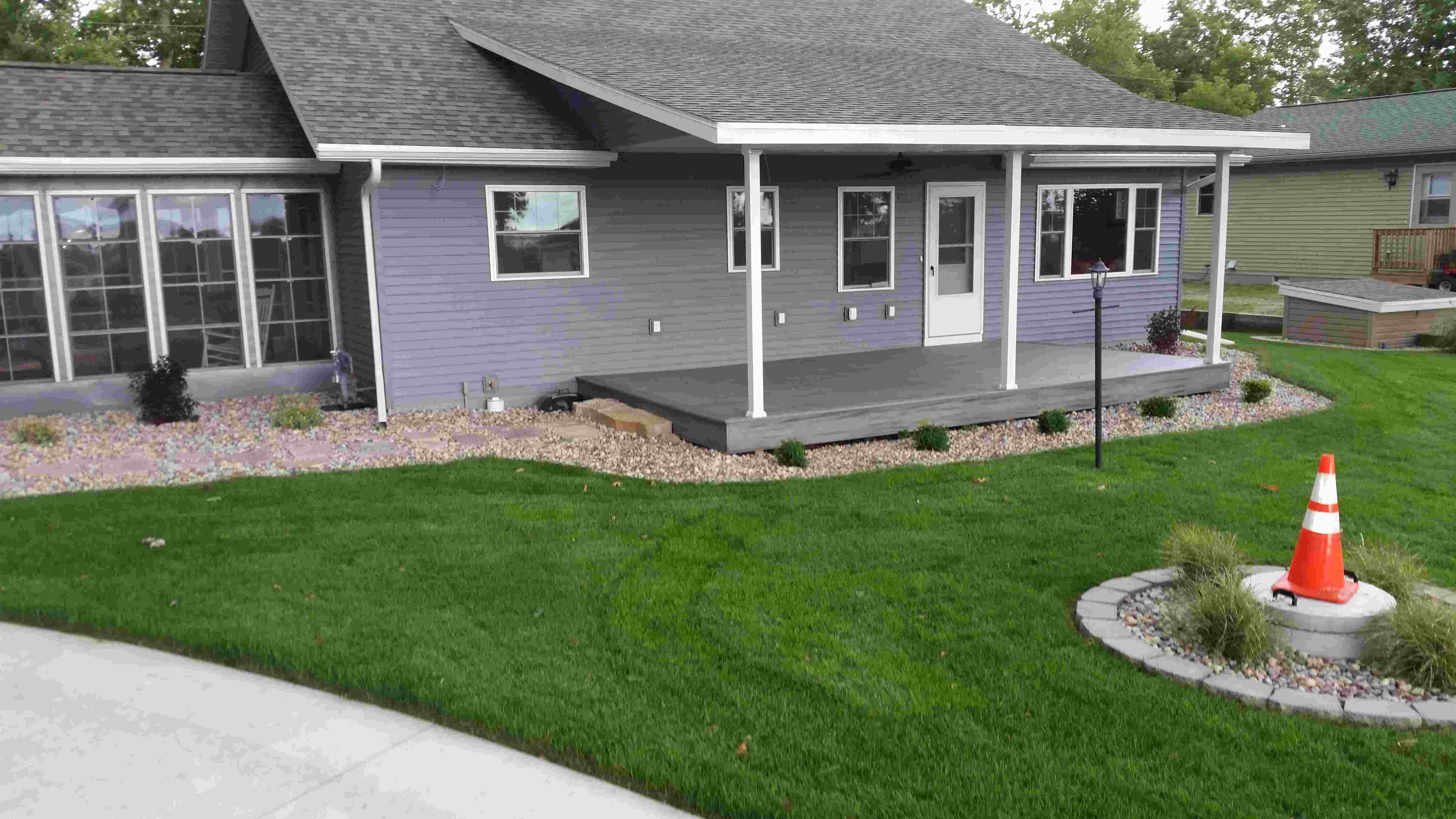 Driveway, well manicured lawn and front of house