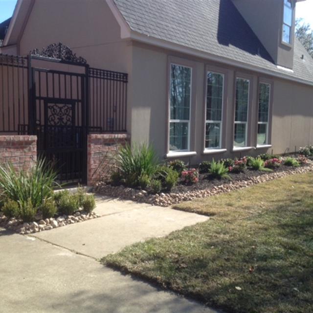 Grass yard and plantation in front of house