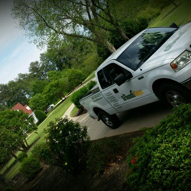 Grounds Guys Car Parked on a drive way