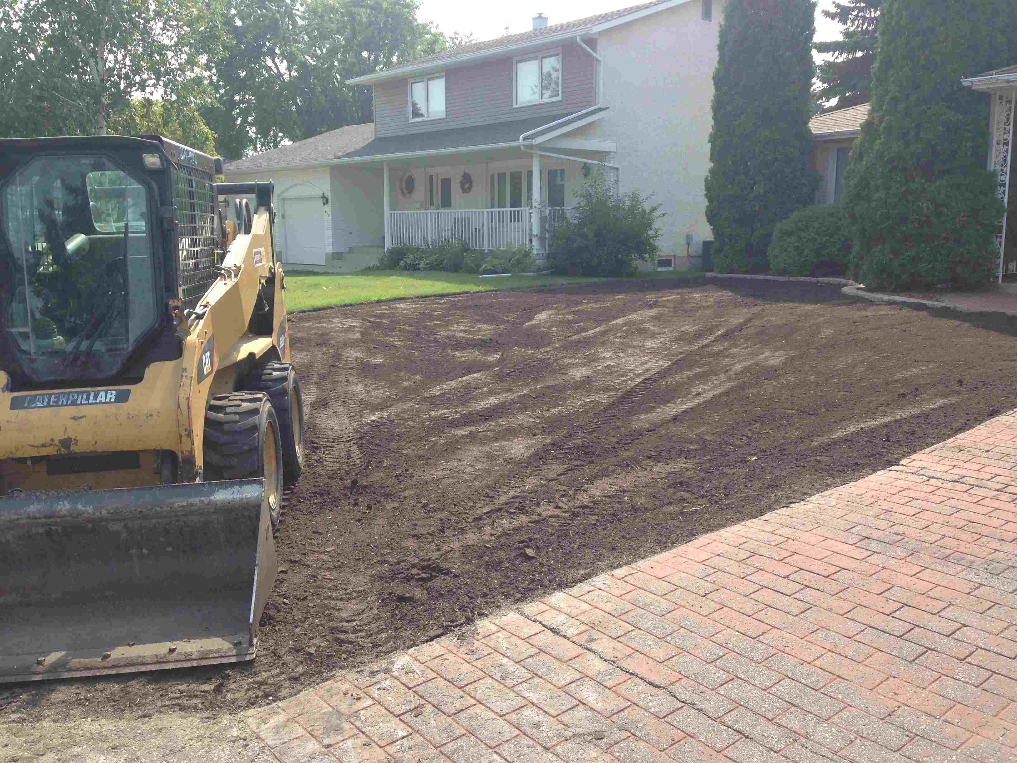 Heavy Machinery grading a front yard