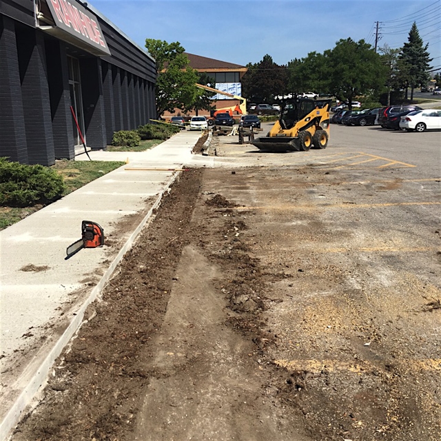 Lawn maintenance using heavy machinery.