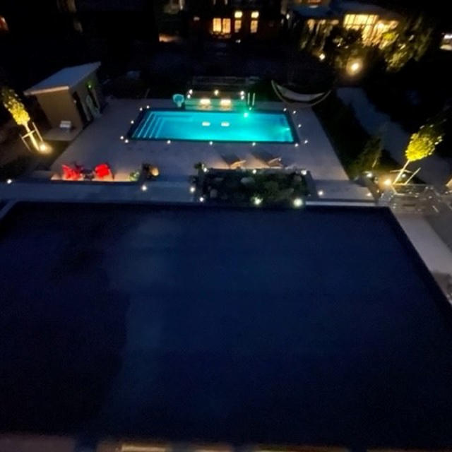 Night view of a backyard pool