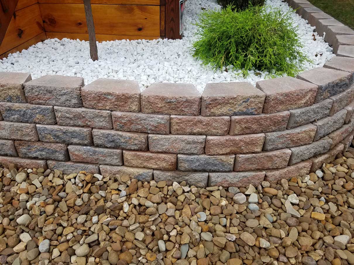 Stone retaining wall and gravel filled planter