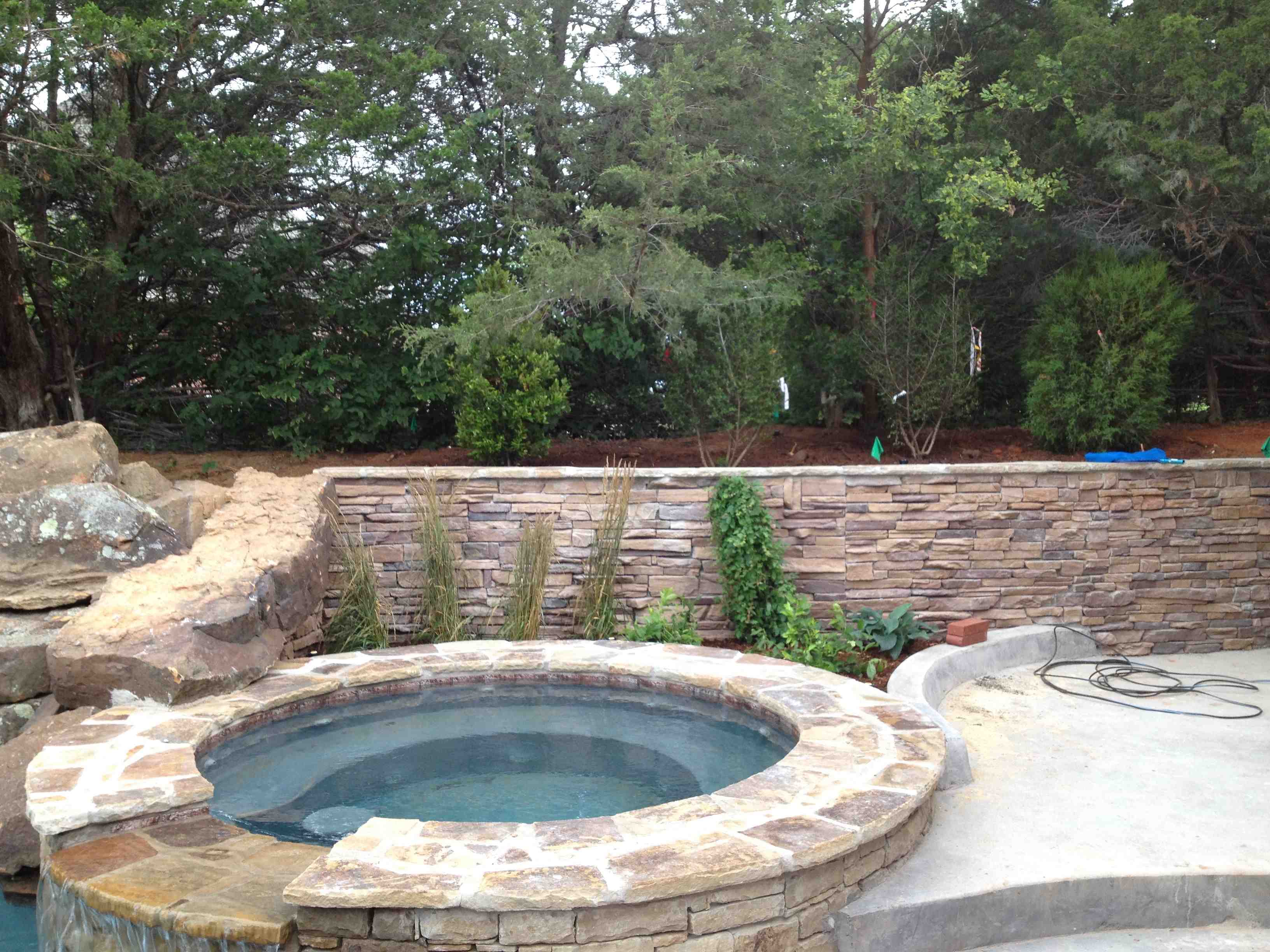 Stone wall with concrete and stone hottub