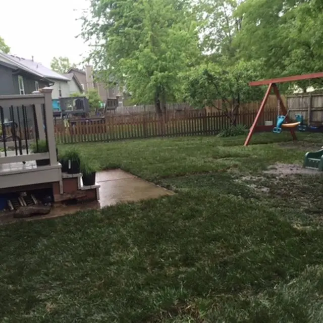 backyard with swing set after a rain storm