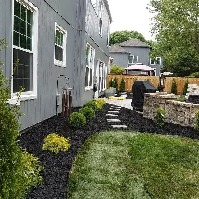 manicured backyard with grill and walkway