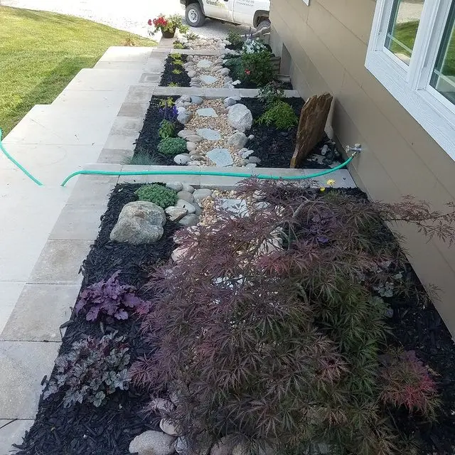 raised flower beds next to sidewalk