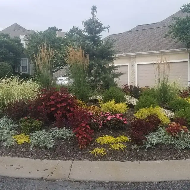 colorful flower bed with stone edging