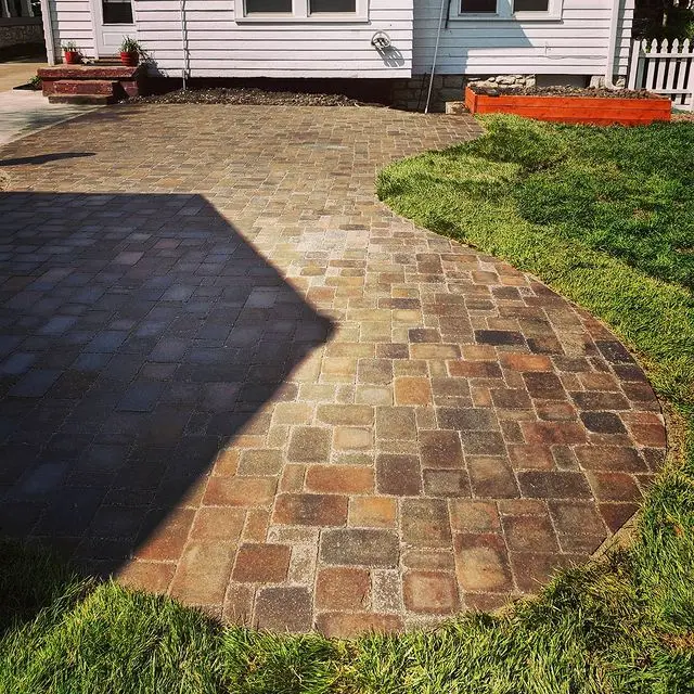 brown brick patio in manicured yard