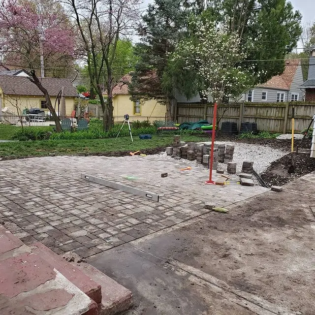 brick patio being laid in a yard