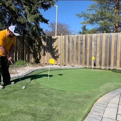 technician testing out a new putting green