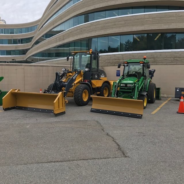 The Grounds Guys vehicles parked in parking lots