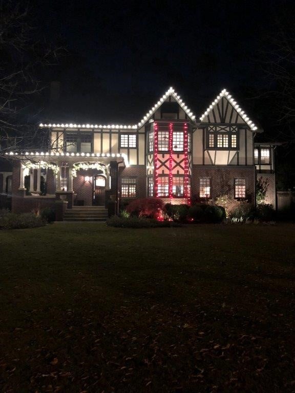 Two story house with white and red lights 