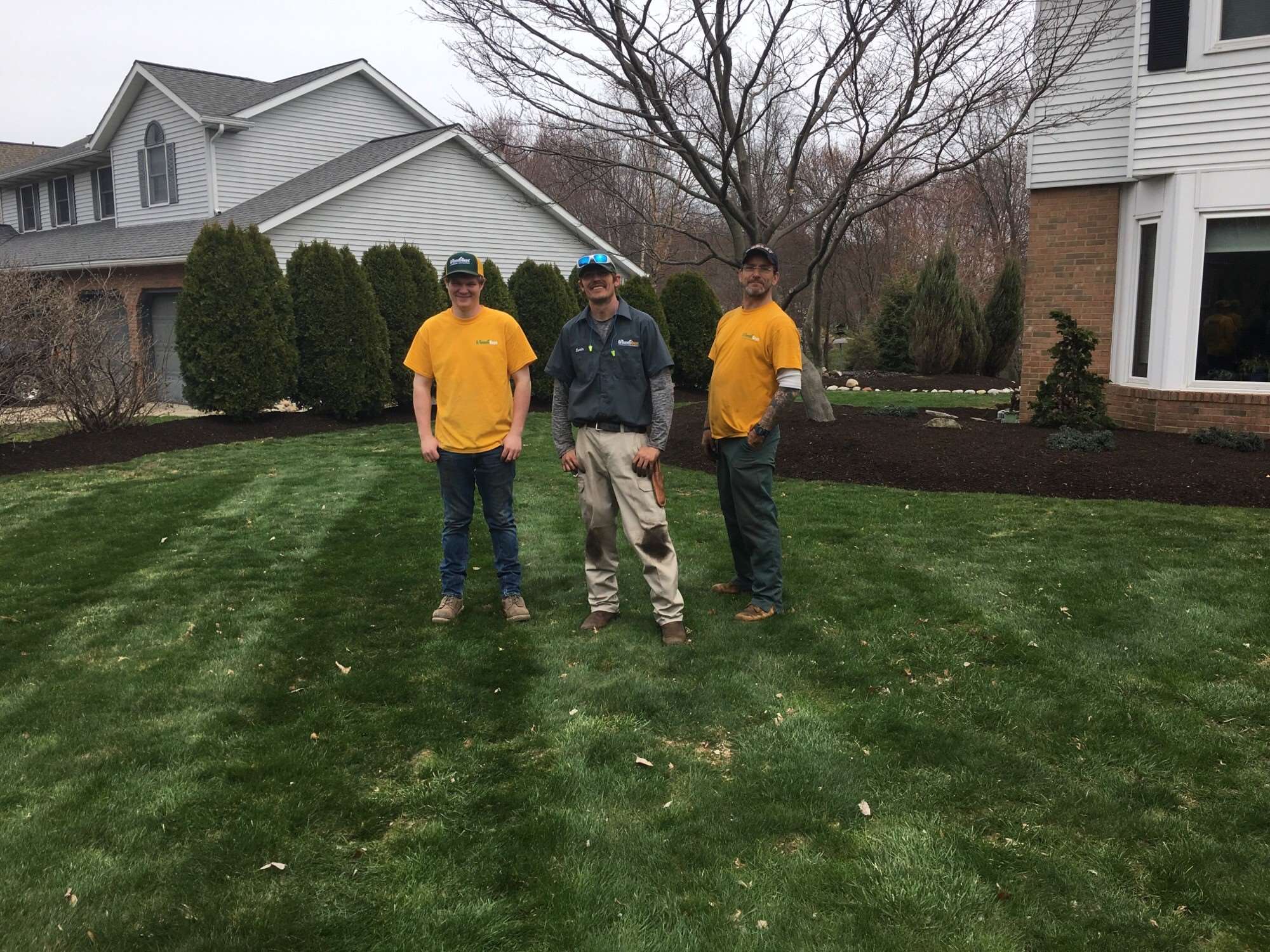 Well manicured lawn and Grounds Guys workers 