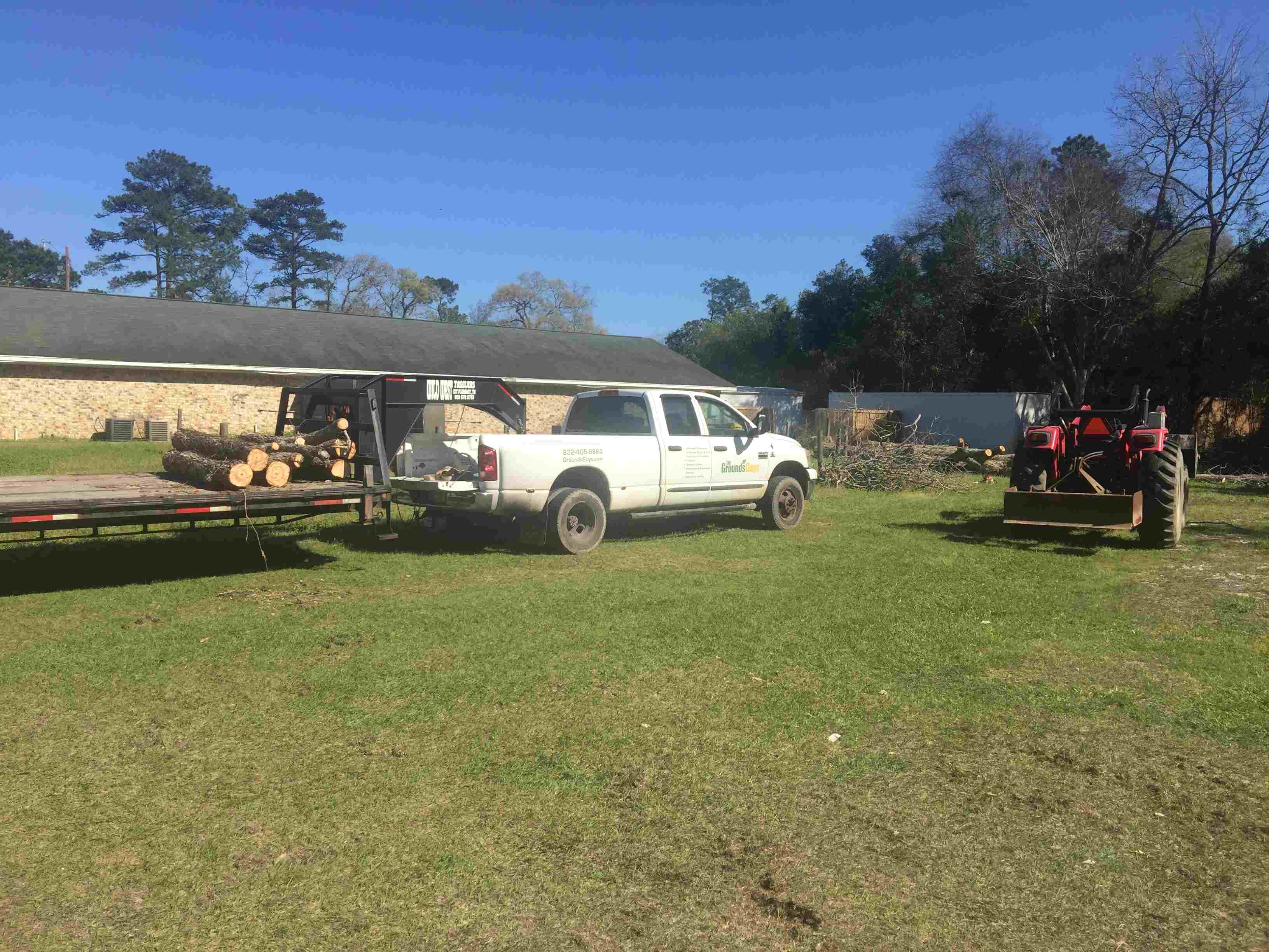 White truck in front of tan home on yard