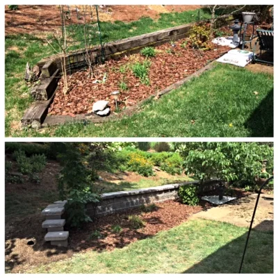 grass with rail road tie planter with woodchips and plants.