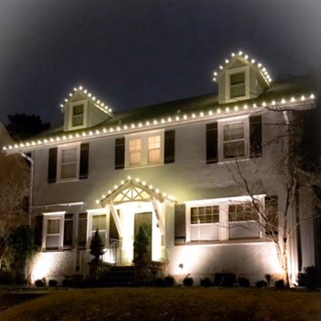 house with outdoor lights at night.