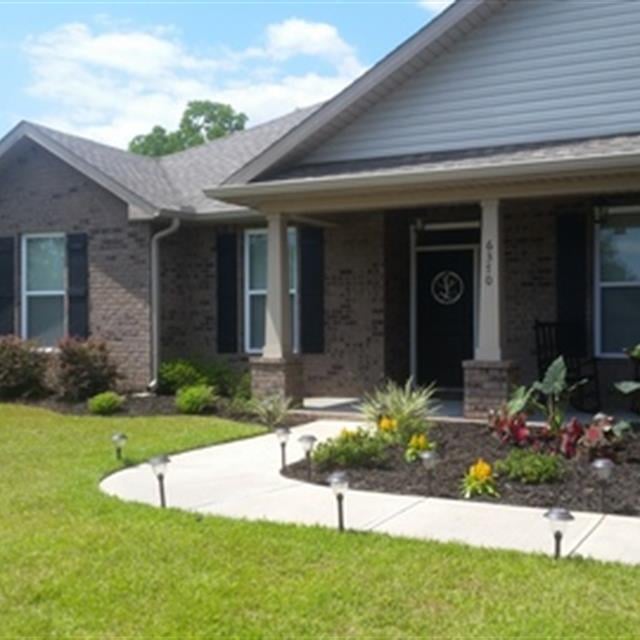 A well-maintained garden and lawn of a house.