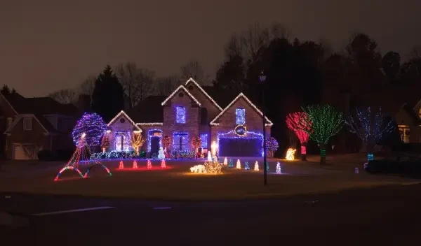 House at night decorated with colorful Christmas lights.