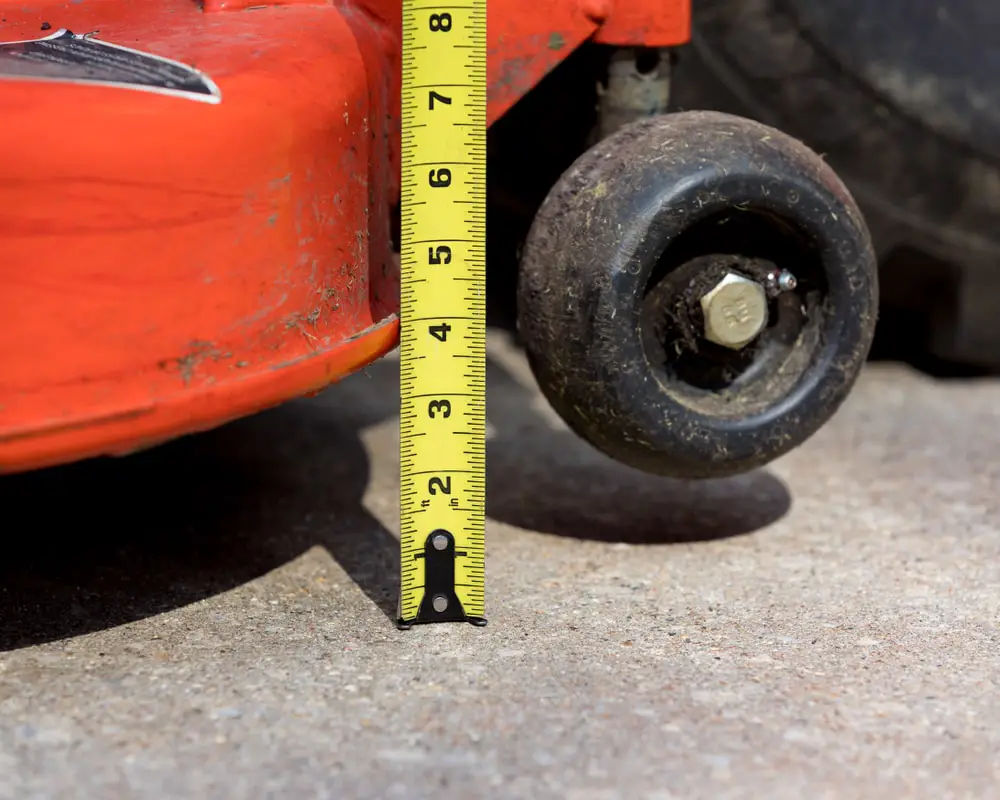 Tape measurer next to lawn mower