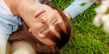 Woman resting on a lawn.