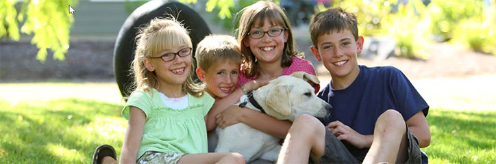 Children with dog in backyard.